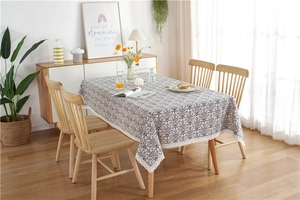 Close-up of beige vintage floral tablecloth with elegant white lace border detail