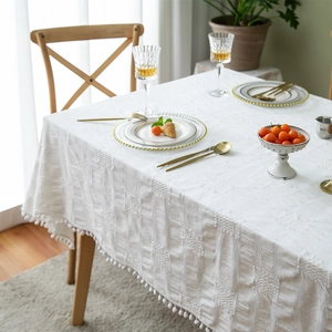 Romantic white cotton tablecloth with woven lattice patterns and elegant pom pom tassels