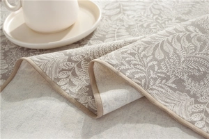 Close-up of American pastoral leaf print tablecloth showing woven texture and hemmed edge