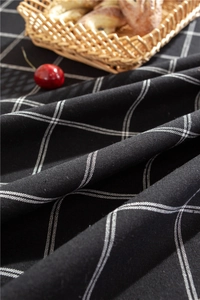 Detail of black and white grid linen tablecloth with soft texture and natural drape
