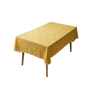 Yellow rectangular tablecloth with jacquard lattice pattern and white pompom tassel fringe