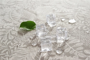 Close-up of waterproof polyester floral tablecloth showing water droplets and texture