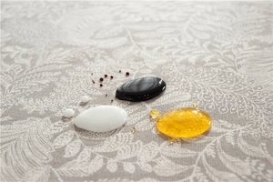 Detailed close-up of water droplets on waterproof floral polyester tablecloth fabric