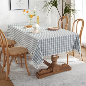 Rectangular grey-green and white checkered tablecloth with decorative tassel trim edge