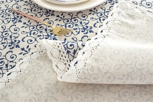Detail of vintage navy floral tablecloth with intricate wide white crochet lace edge