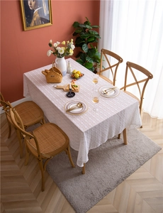 Detail of white French floral lace tablecloth with intricate hollow crochet textures