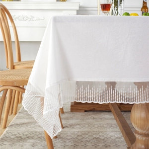 French style white cotton tablecloth with romantic lace trim on wooden dining table