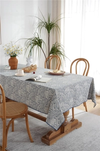 Detail of waterproof tablecloth featuring pastoral grey-blue leaf patterns and neat edges
