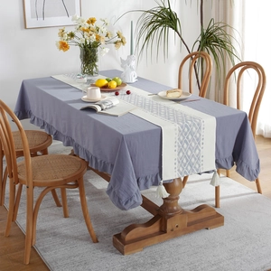 Modern grey-blue cotton tablecloth with ruffled edges and geometric patterned table runner