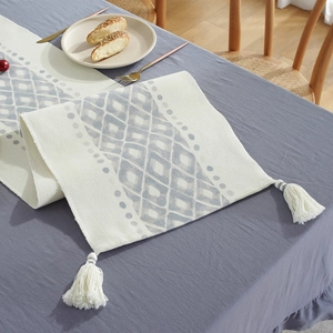 Modern cotton table runner with blue geometric diamond pattern and white tassels
