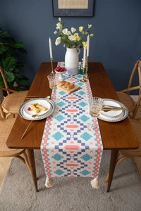Ethnic geometric table runner with blue and orange patterns and cotton tassels decoration