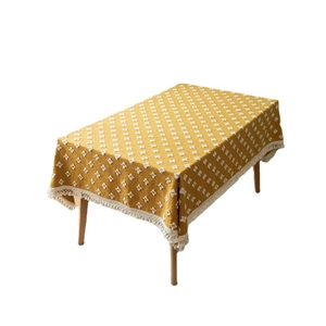 Retro mustard yellow jacquard tablecloth with white textured floral patterns and fringe