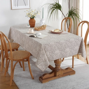 Pastel floral waterproof tablecloth with leaf patterns on a wooden dining table