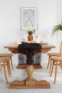 Detailed view of elegant black lace table runner with intricate floral embroidery