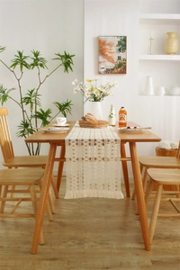 Detailed macro of the woven cotton hollow geometric patterns and fringe on the table runner