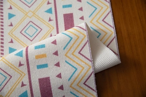 Detailed close-up of bohemian woven table runner showing thick cotton texture and geometric patterns