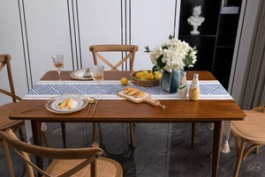 Detailed close-up of blue geometric diamond table runner with thick white cotton tassels