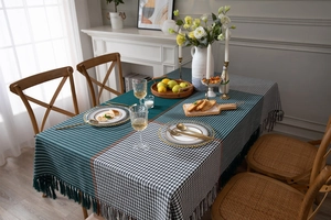 Detail of thick houndstooth tablecloth with fringed edges and geometric jacquard fabric