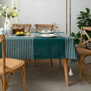 Detail of green and white plaid jacquard tablecloth with white handmade fringe tassels