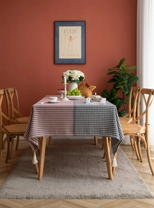 Close-up of houndstooth tablecloth texture with elegant white corner tassel details