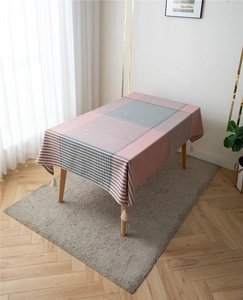 Detail of modern pink and grey geometric lattice tablecloth with soft corner tassels