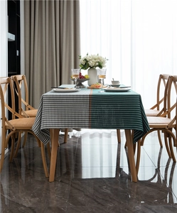 Detailed view of houndstooth and forest green plaid jacquard tablecloth fabric texture