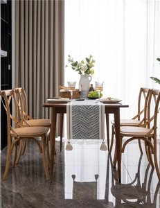 Detailed view of bohemian table runner with wave patterns and elegant fringe tassels