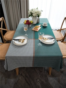 Detail of geometric houndstooth and dark green jacquard fabric texture for dining table