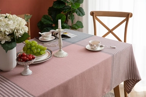 Close-up of pink and white checkered tablecloth texture with elegant tassel fringe edge