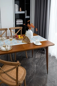 Detail of walnut wood dining table with natural grain and metal leg accents