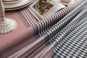 Close-up of houndstooth patterned tablecloth with fringe detail and vintage decor