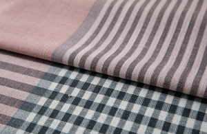 Detail of pink and grey jacquard fabric layers showing stripes and grid weave textures