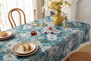 Close-up of vintage blue daisy jacquard fabric with elegant cream cotton fringe details