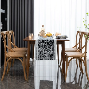 Modern black and white table runner with bold typography on a walnut dining table