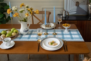 Close-up of blue geometric checkered table runner with modern home dining setting
