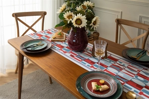 Detailed close-up of modern table runner with red and blue geometric letter patterns