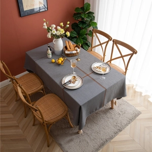 Modern grey and monochrome plaid tablecloth with brown accent lines and white tassels