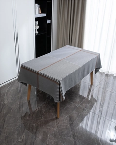 Modern rectangular tablecloth featuring grey houndstooth pattern with orange geometric lines