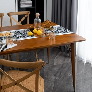 Minimalist jacquard table runner with English letters on a walnut wood dining table