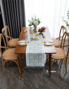 Detail of chenille table runner with geometric triangles and elegant bead tassels