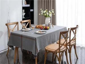 Detail shot of the houndstooth jacquard tablecloth fabric with brown border trim