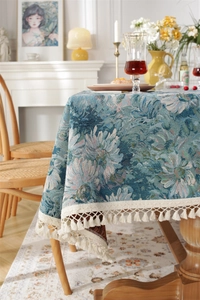 Close-up of vintage jacquard fabric texture with floral pattern and white tassel fringe