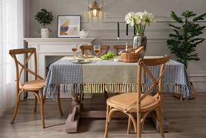 Detail of yellow and grey houndstooth tablecloth with elegant fringe tassels on the edge