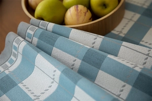 Close-up of modern blue and grey geometric plaid table runner with woven texture detail