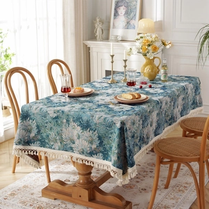 Vintage jacquard tablecloth with blue floral pattern and elegant beige tassel edges