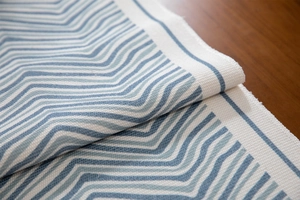 Close-up of blue and white chevron woven fabric with durable texture for home decor