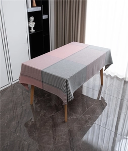 Close-up of geometric houndstooth jacquard tablecloth with pink and grey stripe patterns