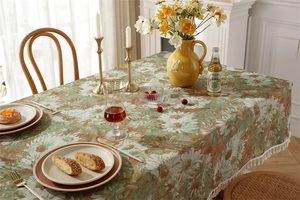 Detail of floral jacquard tablecloth with white tassel edge in French vintage style