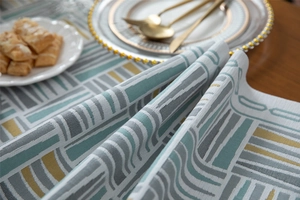 Close-up of chenille table runner featuring jacquard geometric patterns and fabric texture