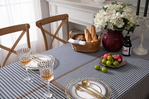 Detail of black and white houndstooth tablecloth with geometric patterns in a dining setting